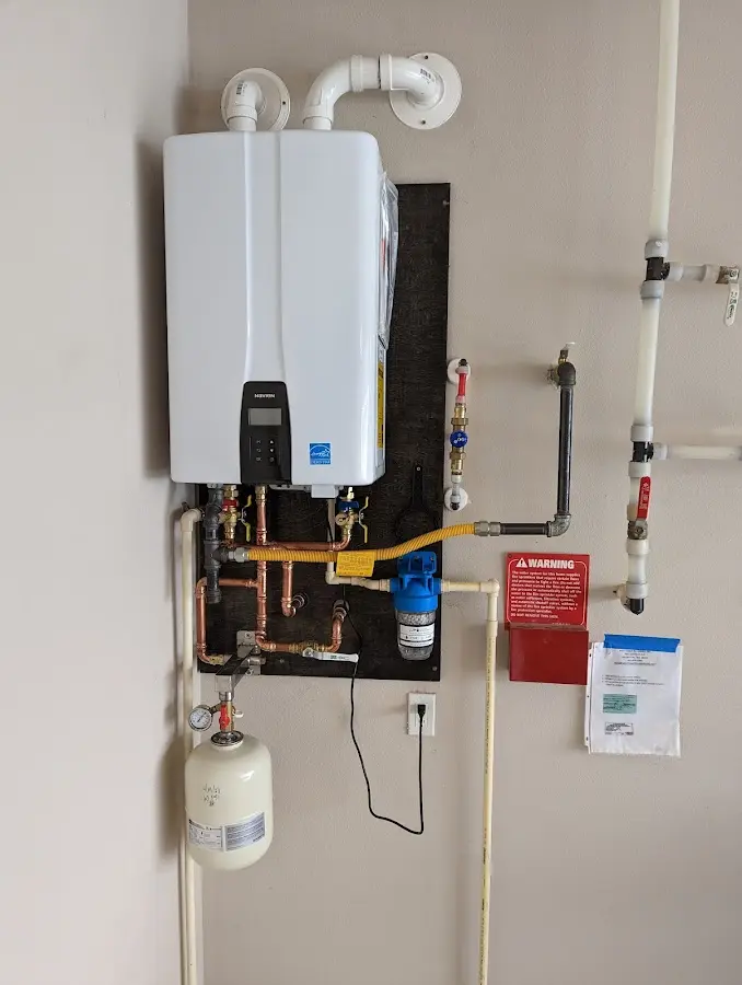 Professional plumber installing copper piping in a Paxton home